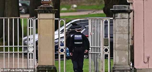 Police officers walk through the gated entrance to Royal Lodge, a 30-room property and former residence to Britain's former prince Andrew where police said they are still conducting a search, in Windsor, west of London on February 20, 2026, a day after Andrew Mountbatten-Windsor was arrested on the royal family's remote Sandringham estate in eastern England. Britain's royal family was thrown into crisis on February 19 after former prince Andrew was arrested by police and held for hours, in a blow to the monarchy unprecedented in modern British history. (Photo by Ben STANSALL / AFP via Getty Images)