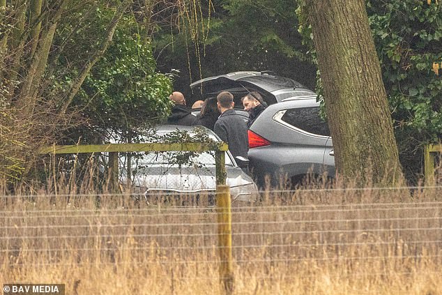 A group of police officers in plain clothes arrive at Wood Farm on Thursday morning, where searches began