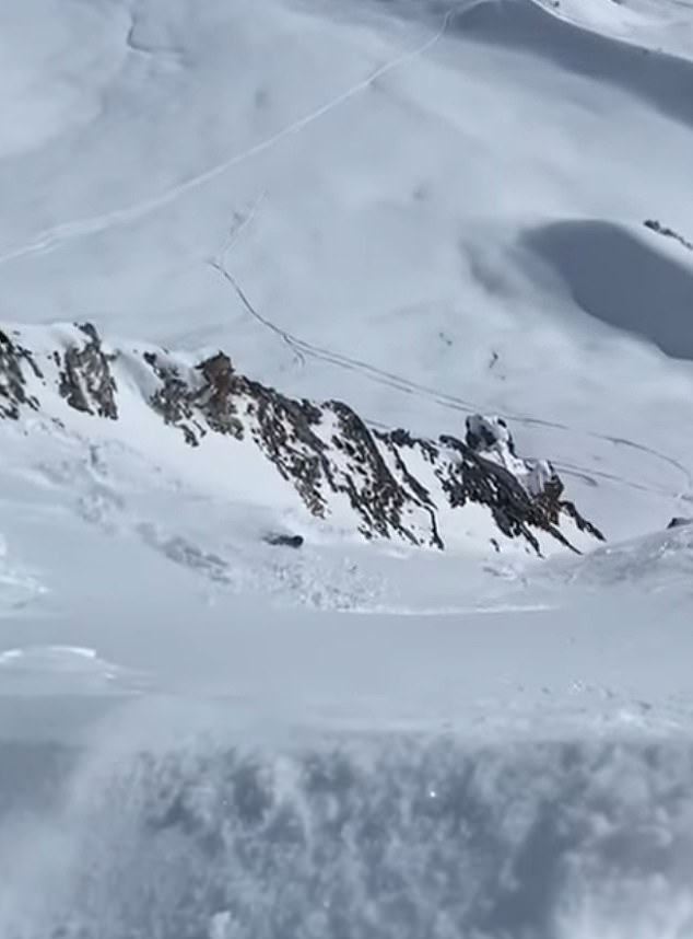 Footage taken by his friends from the top of the mountain show how he was wiped out by the pile of snow