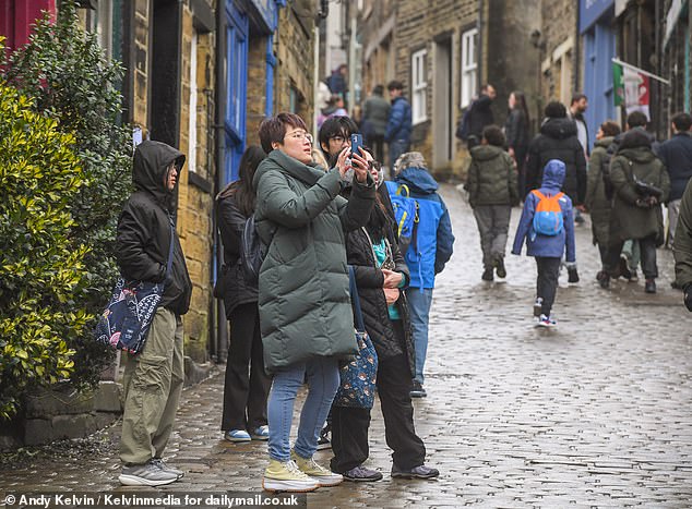 One local historian has also highlighted how some bewildered visitors (pictured) have shown up assuming the village - which is home to 6,259 residents - is 'not real' believing it to be 'some sort of Disneyland'