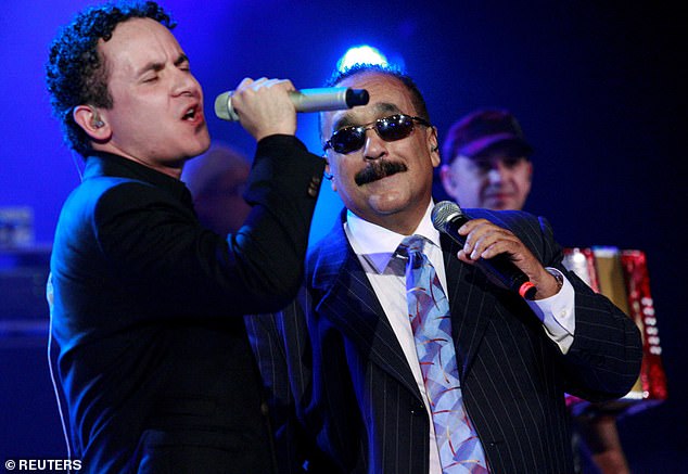 Colón (right) on stage with singer Fonseca in 2010