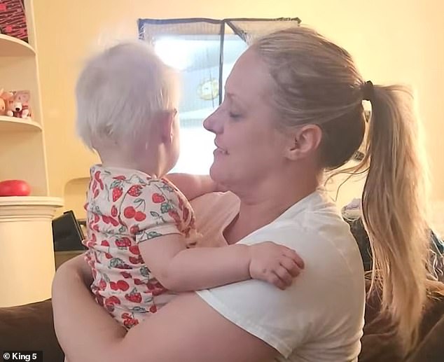 Lauren Jane Morris, 38, was taken into custody by ICE agents outside the Spokane County Courthouse on February 11. Her family claims she was detained in front of her 16-month-old daughter (pictured together)