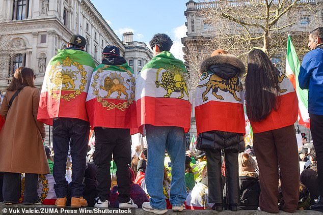 Many demonstrators were seen carrying Union Jacks, Israeli flags, and the Shahist flag of Iran , containing a lion holding a sword as they gathered at Whitehall. Pictured: February 14, 2026