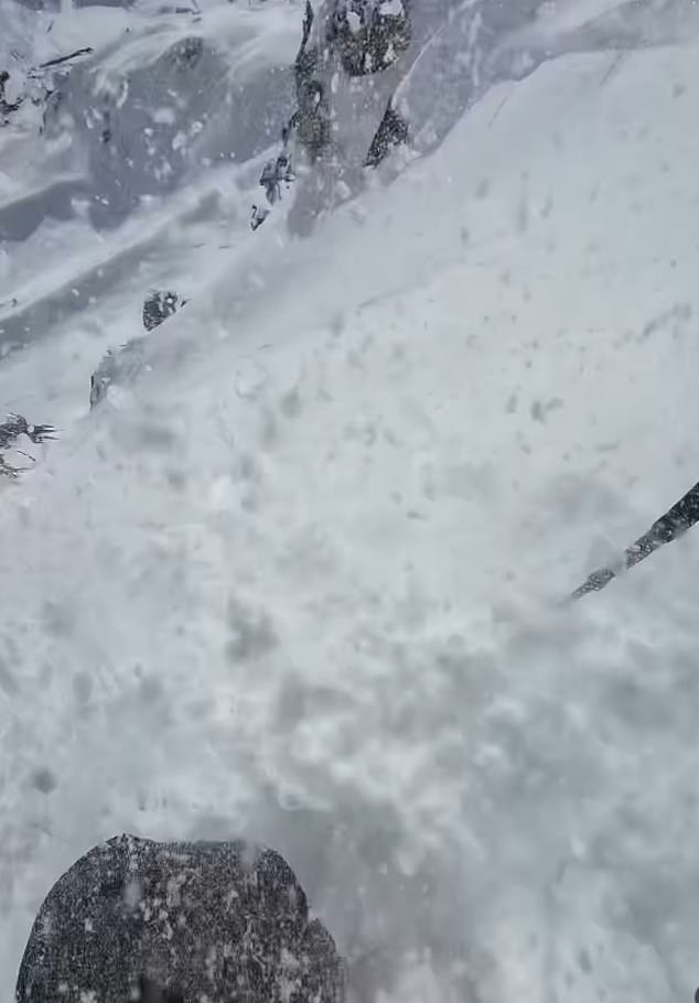 Footage shows how he tumbles downhill rapidly, being flipped over repeatedly, and is left unable to move as he is buried