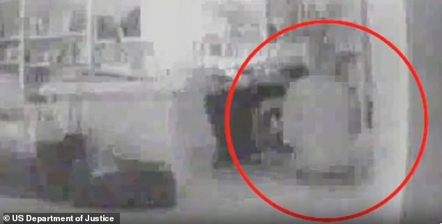 Grainy footage appears to show a young woman kneeling by Jeffrey Epstein's desk. It is unclear when the footage was recorded, but in 2005, police raided Epstein's Palm Beach mansion and discovered a camera inside a clock hidden in his office, and found another in his garage.