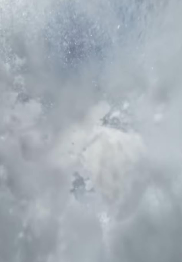 The skier lost consciousness during the terrifying ordeal. Screen grab taken from helmet footage shows piles of snow covering the skier after he was buried under