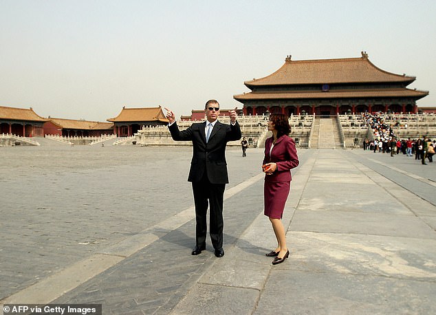He was accused of over-using helicopters at taxpayers' expense. Pictured: Andrew chats with his Chinese guide as he tours the Forbidden City in Beijing in April 2004