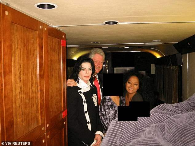 Former U.S. President Bill Clinton, Michael Jackson and Diana Ross are seen in this image released by the Department of Justice in Washington, D.C., U.S., on December 19. It is not clear when or where the image was taken but included in the group is at least one individual whose face has been redacted. There are two other black boxes over smaller faces or identifying features in front of Diana Ross' left shoulder