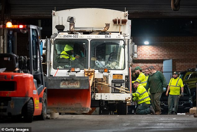 Nearly 54 million Americans are bracing for impact from an intense blizzard that is set to blanket major cities in up to two feet of snow (pictured: snow preparation on New York City)