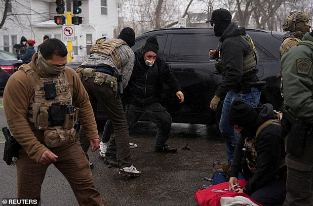 Immigration enforcement operations are likely to continue relatively unimpeded thanks to the Republican bill passed last year that allocated $75 billion to Immigration and Customs Enforcement and $65 billion to Customs and Border Protection over the next four years (Pictured: Federal agents detain locals in Minneapolis on January 21, 2026)