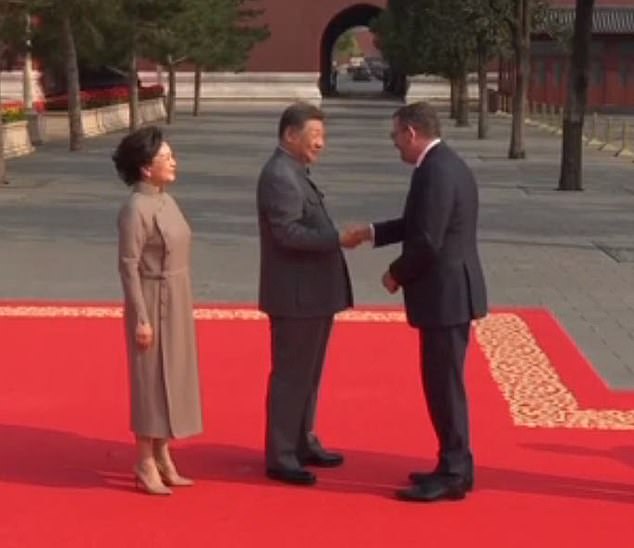 Andrews was also filmed being greeted by President Xi and his wife Peng Liyuan on a red carpet procession before the parade kicked off