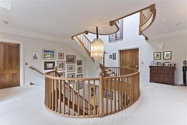 The sweeping staircase leads to 'the first floor's ' impressive main bedroom suite