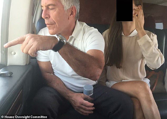 Jeffrey Epstein is seen on a private jet with an unidentified young woman sitting next to him in this undated photo from the Epstein files