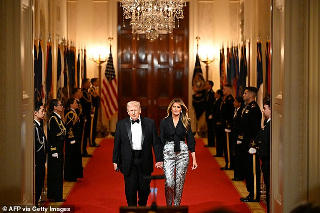 Melania Trump stuns in silver pants as she arrives at controversial Governor's Dinner with husband Donald as dozens threaten boycott after president's turbulent week