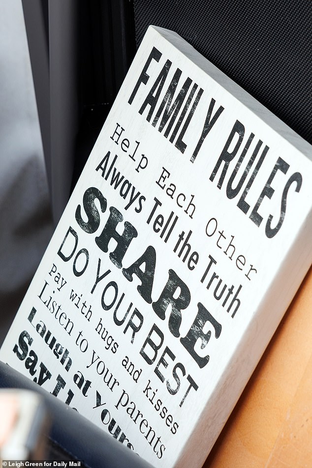 A sign preached 'family rules'-  but Goode was happy to break the law to move her family into the bank-owned mansion