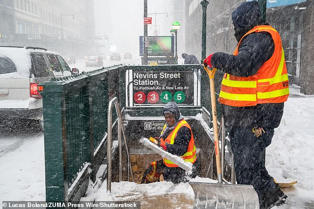 New York will soon be hit with another major snow storm. Pictured above are shovelers clearing out a subway station in Brooklyn