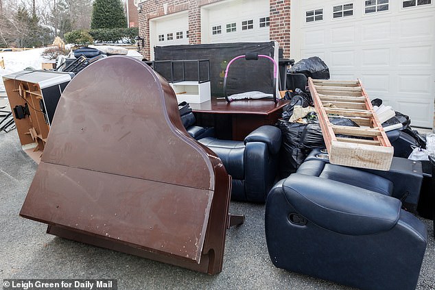 Luxury furniture, including a baby grand piano lies dumped on the driveway of the mansion Goode was squatting in after her eviction