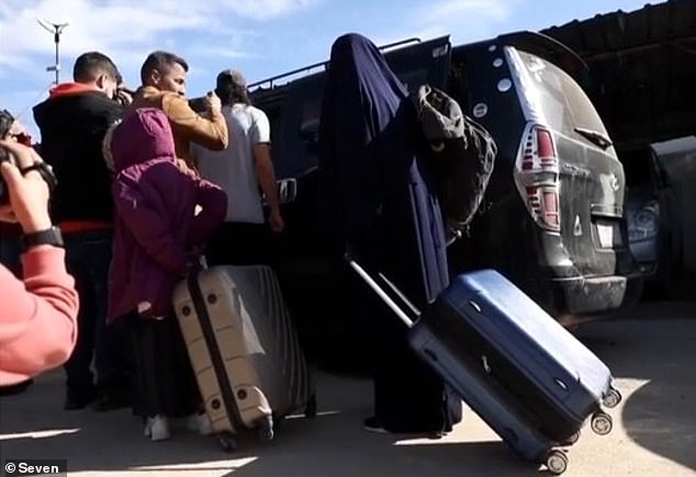 The 11 women and 23 children - all linked to Islamic State members - were granted documents to travel to Australia