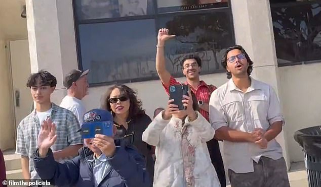 Some of the spectators put their thumbs down and booed at the mayor as she passed them in the vehicle