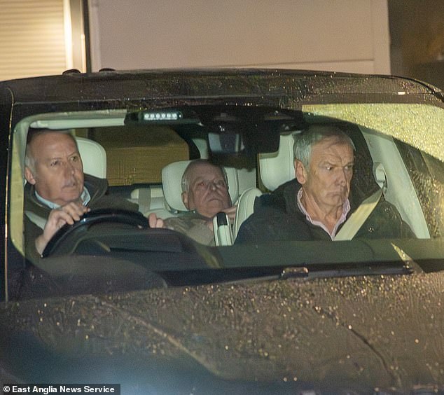 Now you see him, now you don't: Cringeworthy new photos show Andrew trying to hide from photographer as he's driven away from police station after questioning