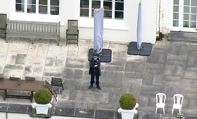 A police officer stood on Royal Lodge's grand patio on Friday as searches at Andrew's former home entered a second day