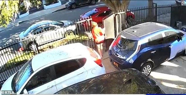 Reel said she chased after the robot and yelled at it to stop, which made her look 'like a total crazy person.' She is pictured exiting the front gate of her home to chase the bot