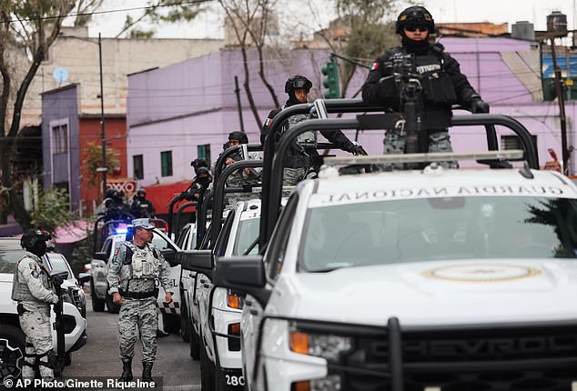 National Guards patrol the area outside of the General Prosecutor's headquarters in Mexico City on Sunday after the killing of the Jalisco New Generation Cartel leader