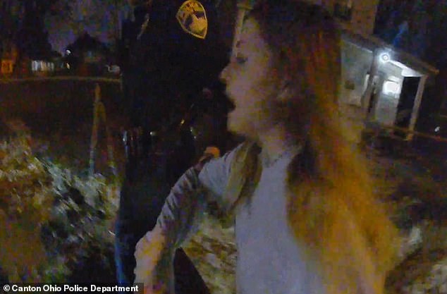 The officer tried to drag her away from the residence and into a patrol car