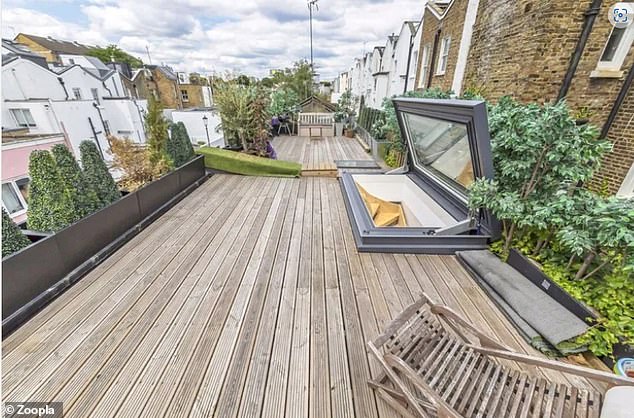 At the centre of the row is this roof terrace, which is now encircled by aluminium plant boxes