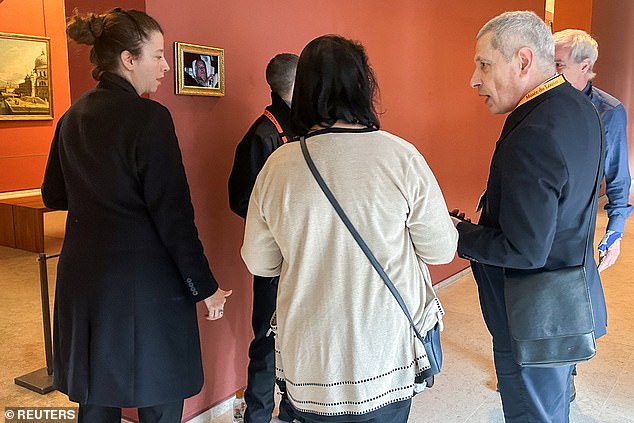 Spectators gathered around the framed picture of Andrew (pictured). The former prince has been in the spotlight after allegations he sent confidential government documents to disgraced financier Jeffrey Epstein