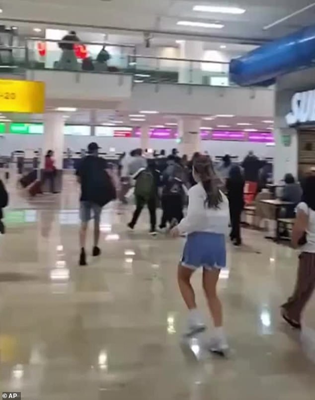 Terror in the terminal: Moment panicking tourists sprint through Mexican airport fearing a cartel attack hours after death of drug lord El Mencho