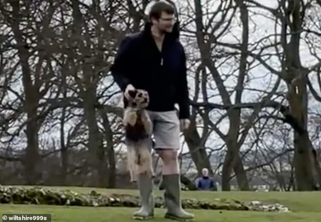 Lib dem council boss is filmed 'scruffing' pet in front of children at park