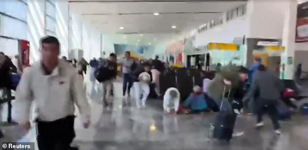 Hundreds of tourists were seen fleeing the airport and diving for cover