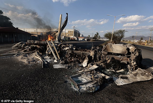A view of a burning truck, allegedly set on fire by organized crime groups in response to an operation to arrest El Mencho which led to his death