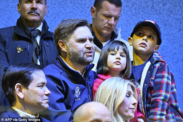 US Vice President JD Vance (C), his children Mirabel and Ewan, and US Secretary of State Marco Rubio (L) attends the women's preliminary round Group A Ice Hockey match