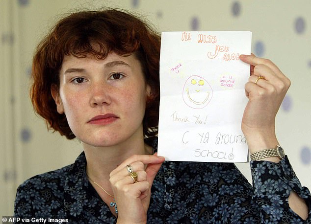 Maxine Carr posing with a card which Holly made for her classroom teaching assistant - as Huntley's duplicitous girlfriend pretended to help the search for the missing girls