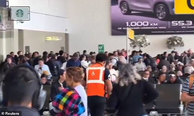 Passengers wait at Puerto Vallarta airport, which is operating with limited personnel