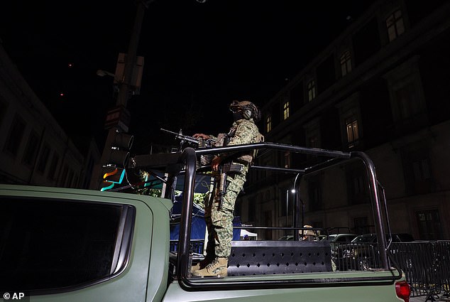 Army soldiers patrol guard the National Palace ahead of the daily, morning news conference by Mexican President Claudia Sheinbaum in Mexico City on Monday