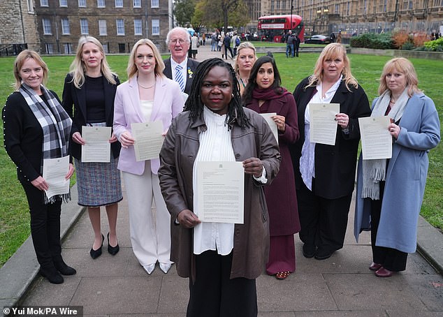 NHS nurse Jennifer Melle (front centre), who was suspended after she referred to a transgender paedophile patient as 'Mr', was allowed to return to work today