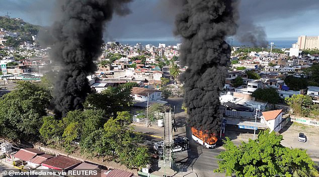 Smoke billows from burning vehicles amid a wave of violence in Mexico following the killing of 'El Mencho' by security forces