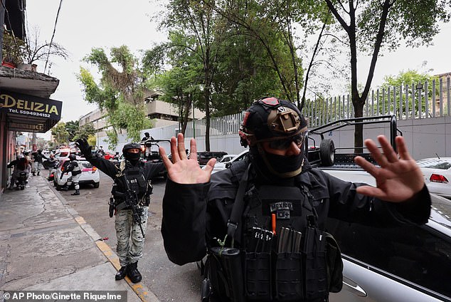 Members of the National Guard move pedestrians along in Mexico City on Sunday