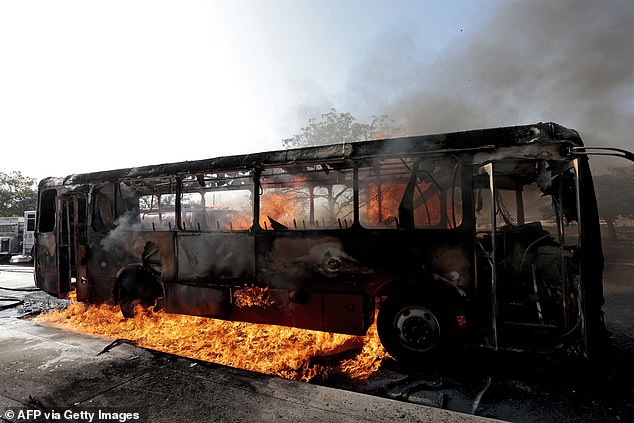 View of a burning bus set on fire by organised crime groups in response to an operation in Jalisco to arrest a high-priority security target, at one of the main avenues in Zapopan, state of Jalisco, Mexico, on February 22, 2026