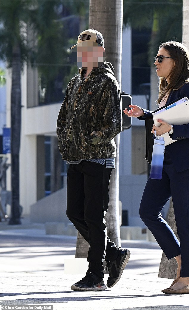 The teenage suspect arriving at federal court in Florida earlier this month