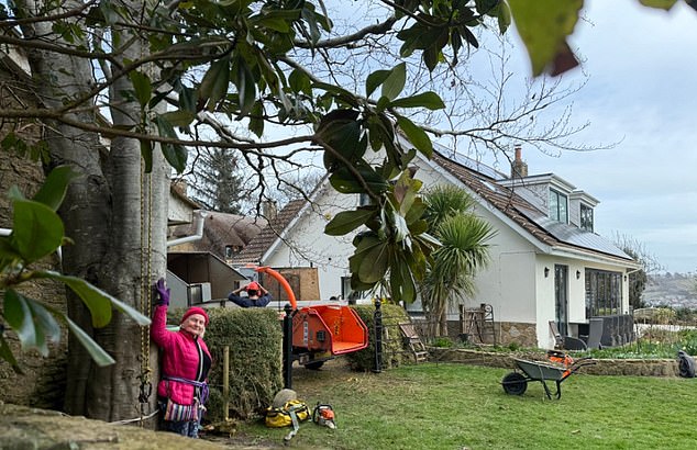 With her husband Carl's help, Mrs Rogers used a length of rope to tie herself to the trunk for her impromptu protest