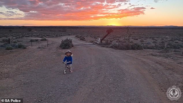Gus is seen barefoot and in a wide-brimmed hat in a new video of him riding a bike