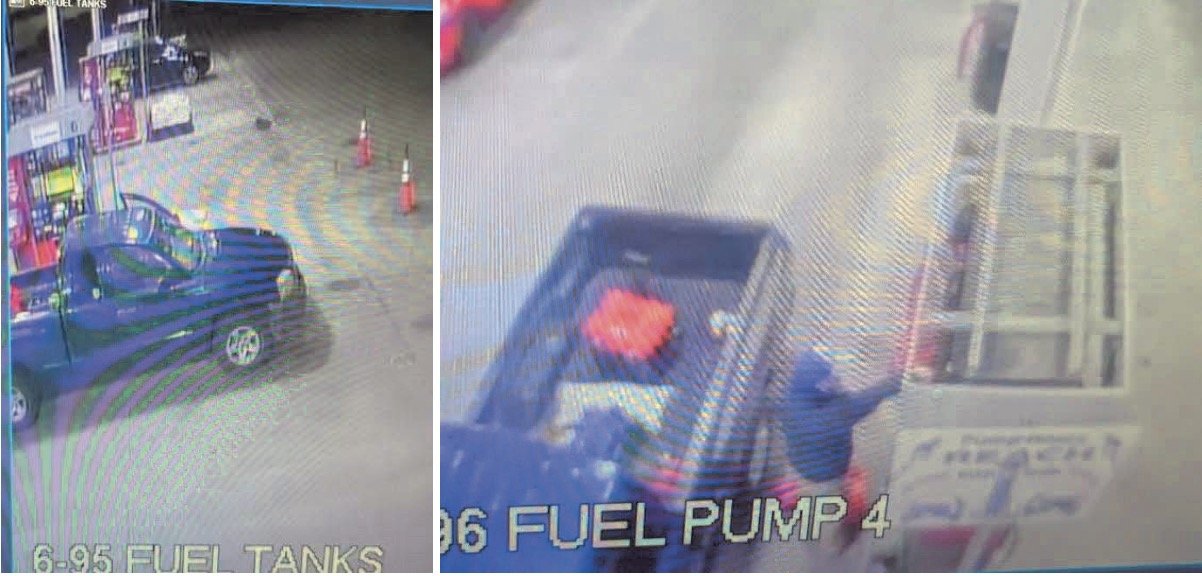 Surveillance footage showing a blue truck at a gas station fuel pump with red traffic cones in the surrounding area.