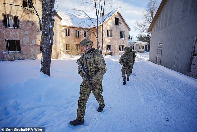 British troops from the Duke of Lancaster's Regiment patrol through snow in Estonia