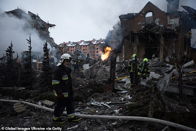 Rescue workers work at the site after a Russian mass missile and drone attack on February 22, 2026 in Kyiv, Ukraine