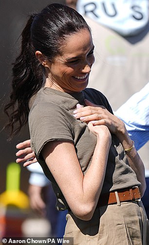The Duchess of Sussex strikes a pose on a visit to the QuestScope Youth Center in Mafraq today