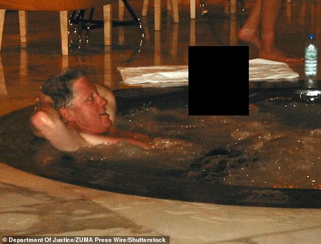 Clinton relaxes in a hot tub with a woman whose face has been redacted in an image from the Epstein files